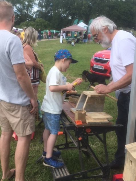John helping young lad to build his box.